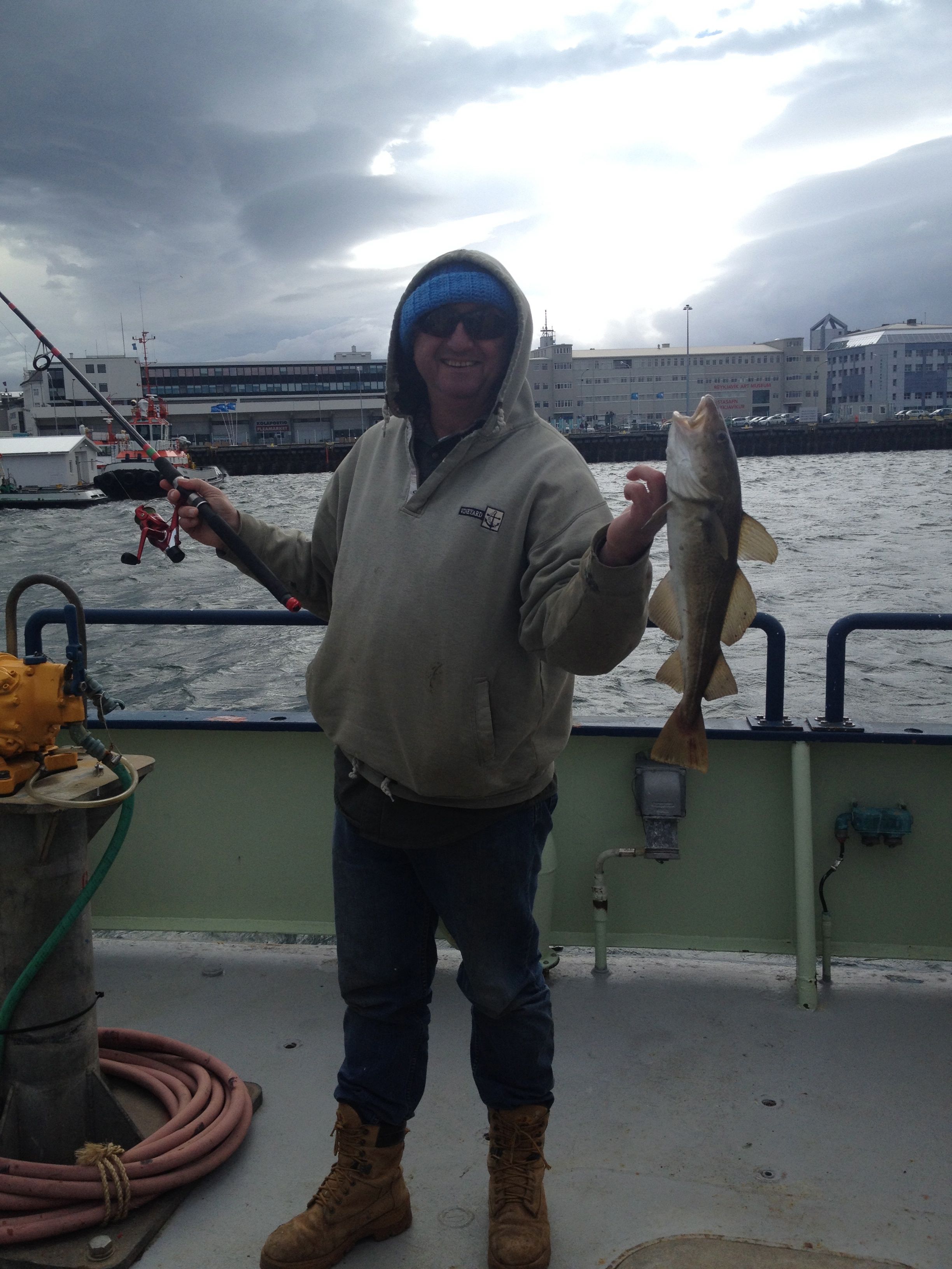 Crew member Leo Fitz catches a cod right off the ship in Reykjavik harbor!