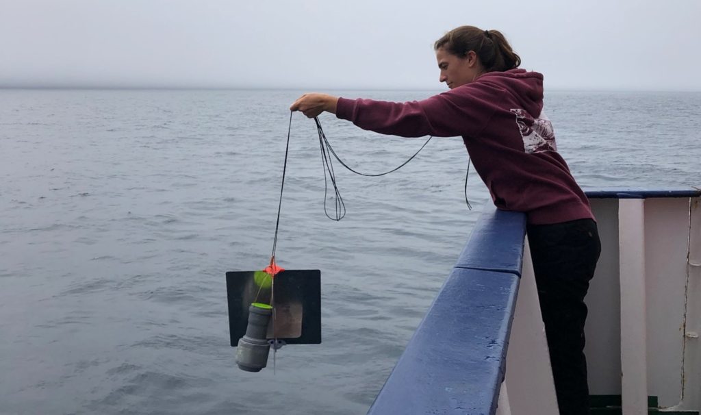 Paula is lowering a Hereon Drifter with a rope at the back of the ship.